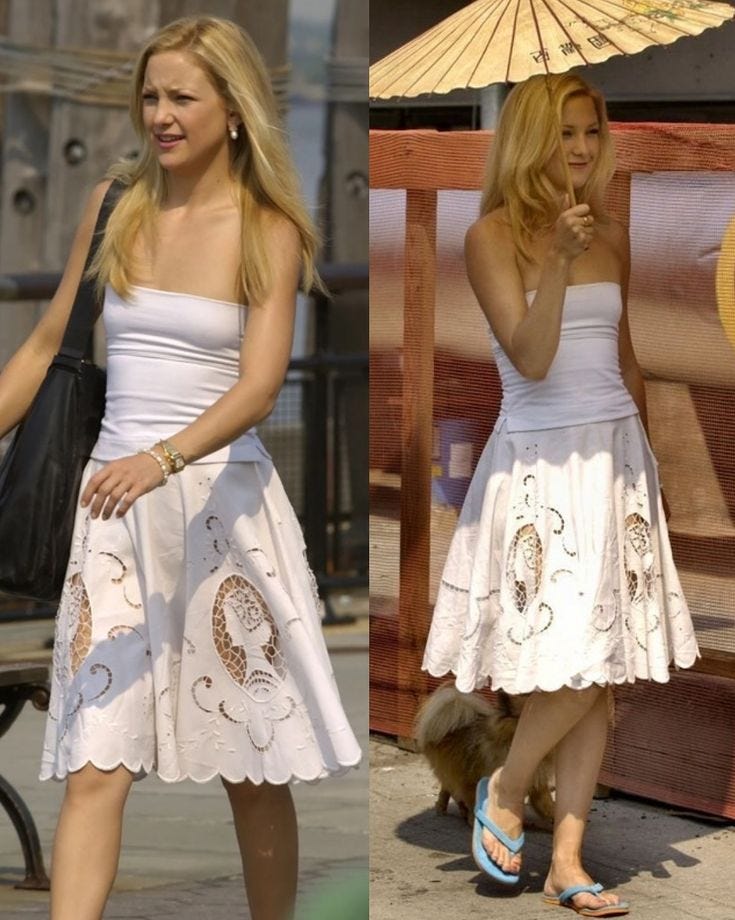 This may contain: the woman is walking down the street with an umbrella over her head, and she's wearing a white dress