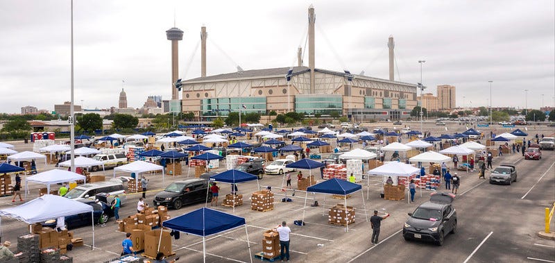 Cars lined up outside the Alamodome in San Antonio to receive food boxes from the San Antonio Food Bank. Cars lined up outside the Alamodome in San Antonio to receive food boxes from the San Antonio Food Bank.