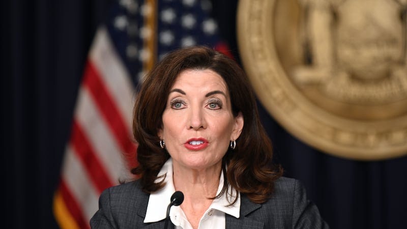 A close up of a woman in front of an American flag. A close up of a woman in front of an American flag.