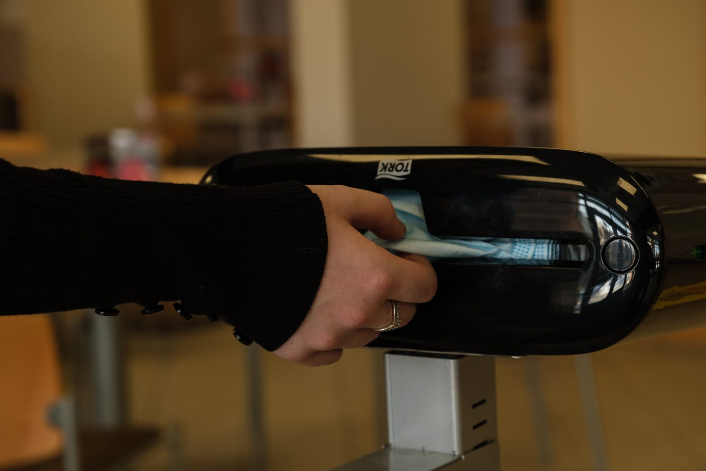 A student grabs a cloth mask from a dispensary in the Wyoming Union.
