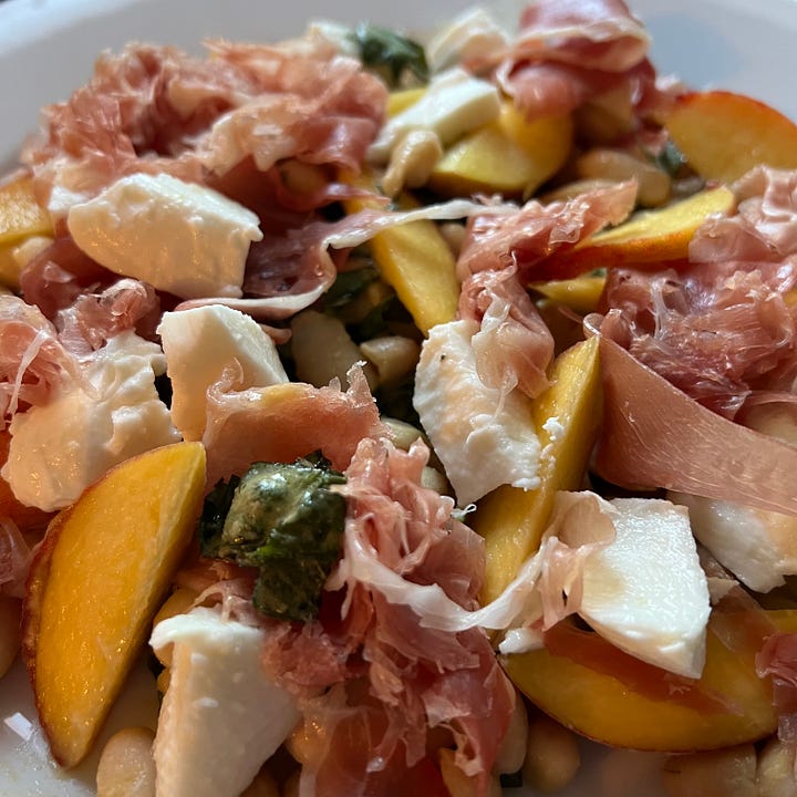 Nectarine & orange salad on vintage plate, peach & serrano ham salad with white beans & mozzarella, tomato salad with burrata & wild garlic pesto, cheeseboard with 4 cheeses, one covered in flower petals