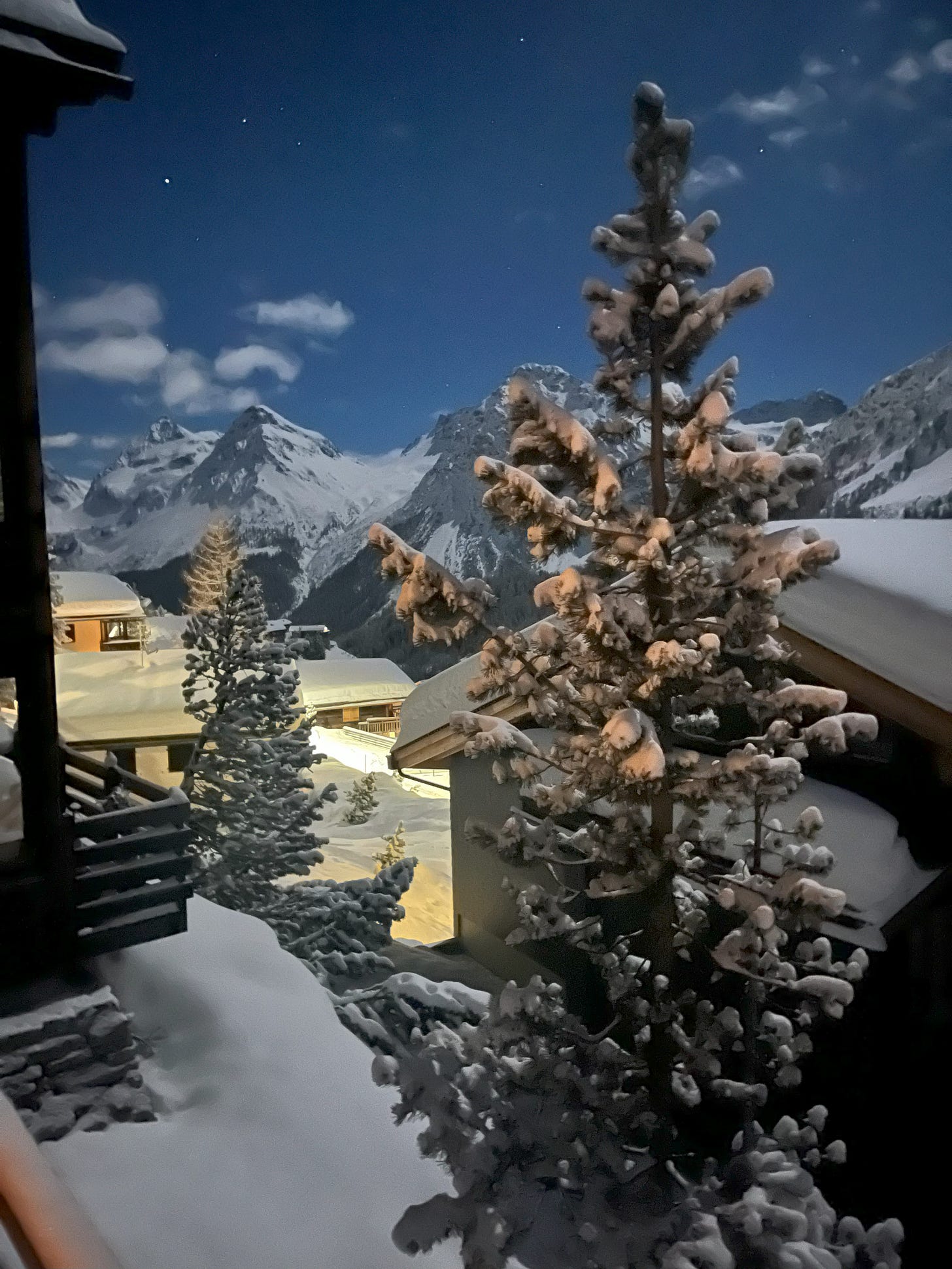 snow topped mountain chalets at night under the stars in Switzerland