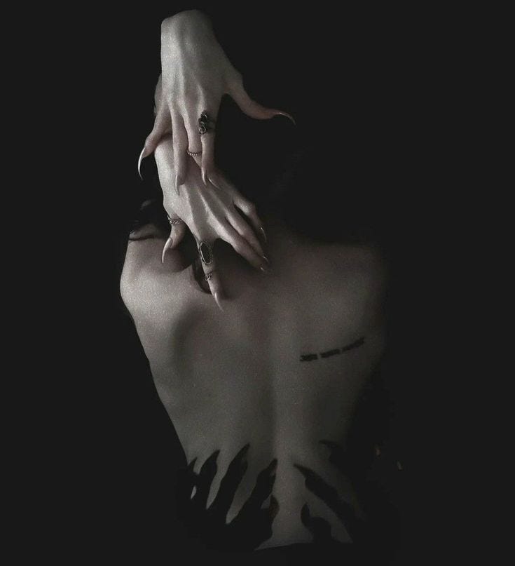 This may contain: a woman with her hands on the back of her head and nails sticking out of her chest