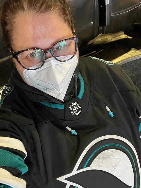 Photo 1: girl in hockey jersey with glasses and mask; Photo 2: girl in green dress smiling; Photo 3: two girls in hockey jerseys at a hockey game; Photo 4: Mexican food on a table with work documents and a red pen; Photo 5: yellow dog at restaurant; Photo 6: two laptop on a bed with work documents and a pen; Photo 7: image of Matt Nathanson doing an online show; Photo 8: image of a rainbow between two trees; Photo 9: image of a girl in a hoodie, a mask and glasses in an empty movie theatre
