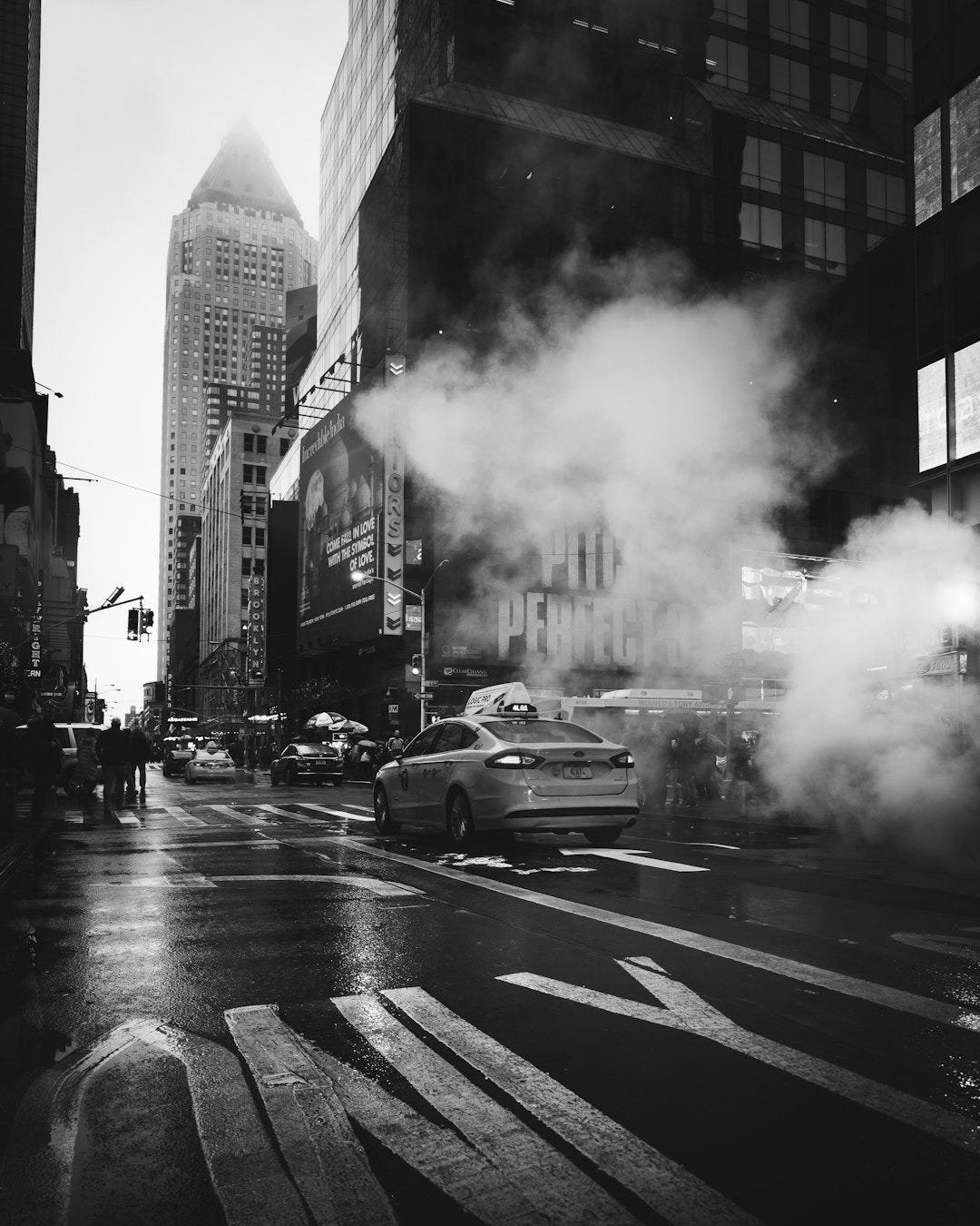 yellow taxi sedan on gray concrete street passed through white smokes near walking lane yellow taxi sedan on gray concrete street passed through white smokes near walking lane