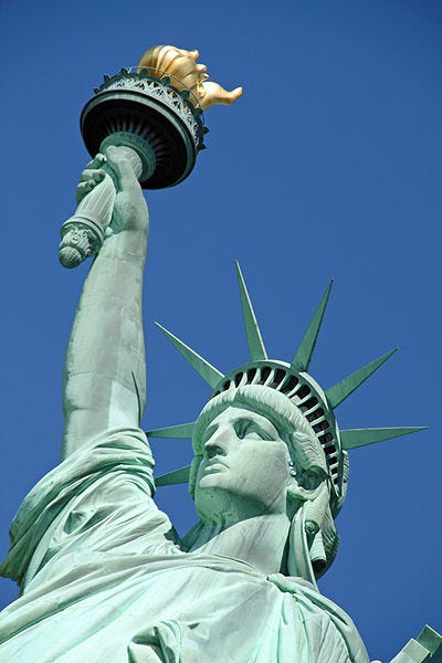 Close-up of a statue of liberty

Description automatically generated
