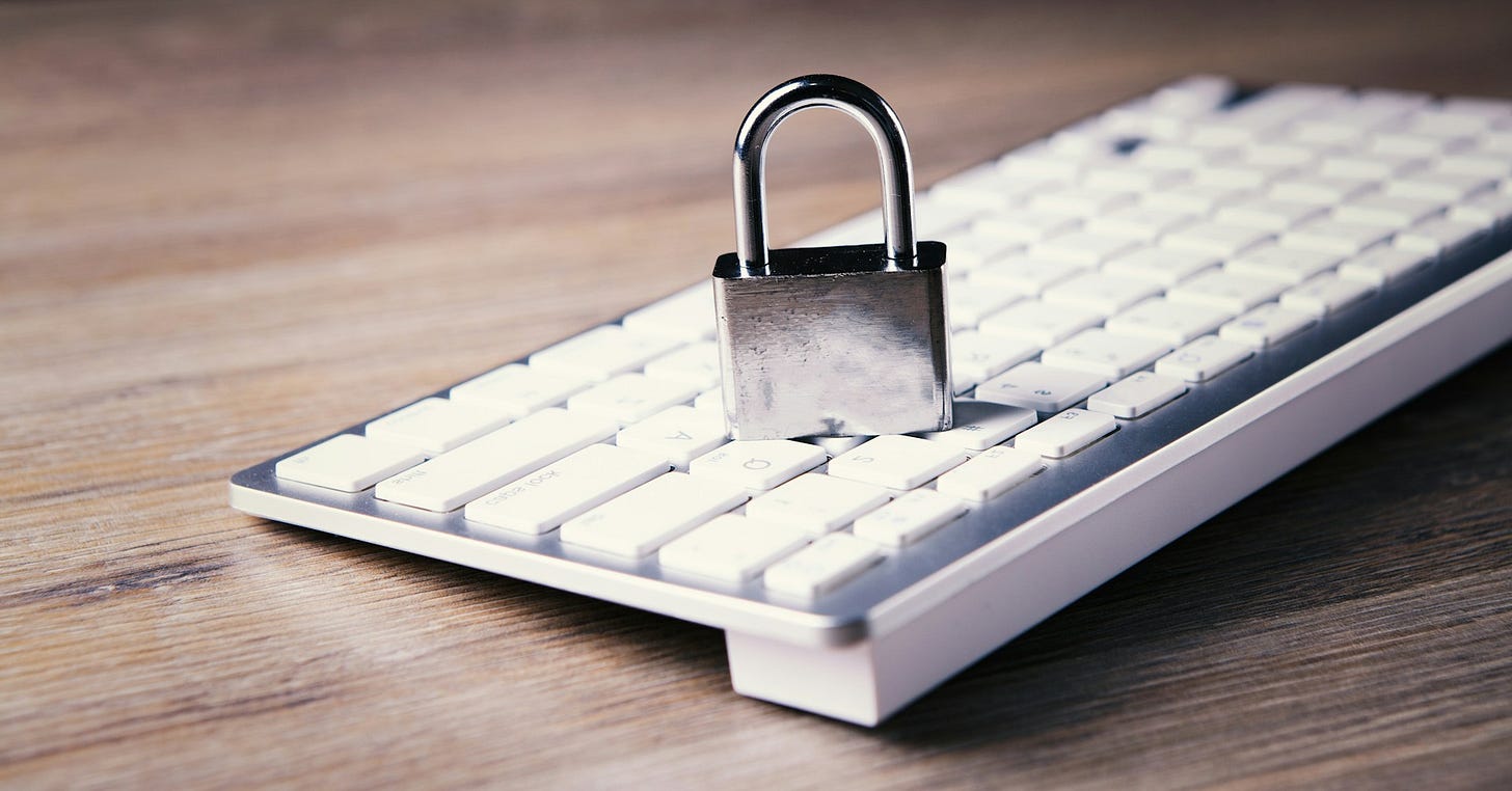 A metal padlock placed on top of a white computer keyboard, symbolizing cybersecurity and protecting financial data. Photo by Sasun Bughdaryan on Unsplash