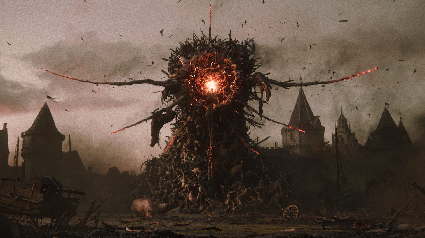 A big stack of fused corpses in Divinity, with a glowing eye-like red circle at the centre.