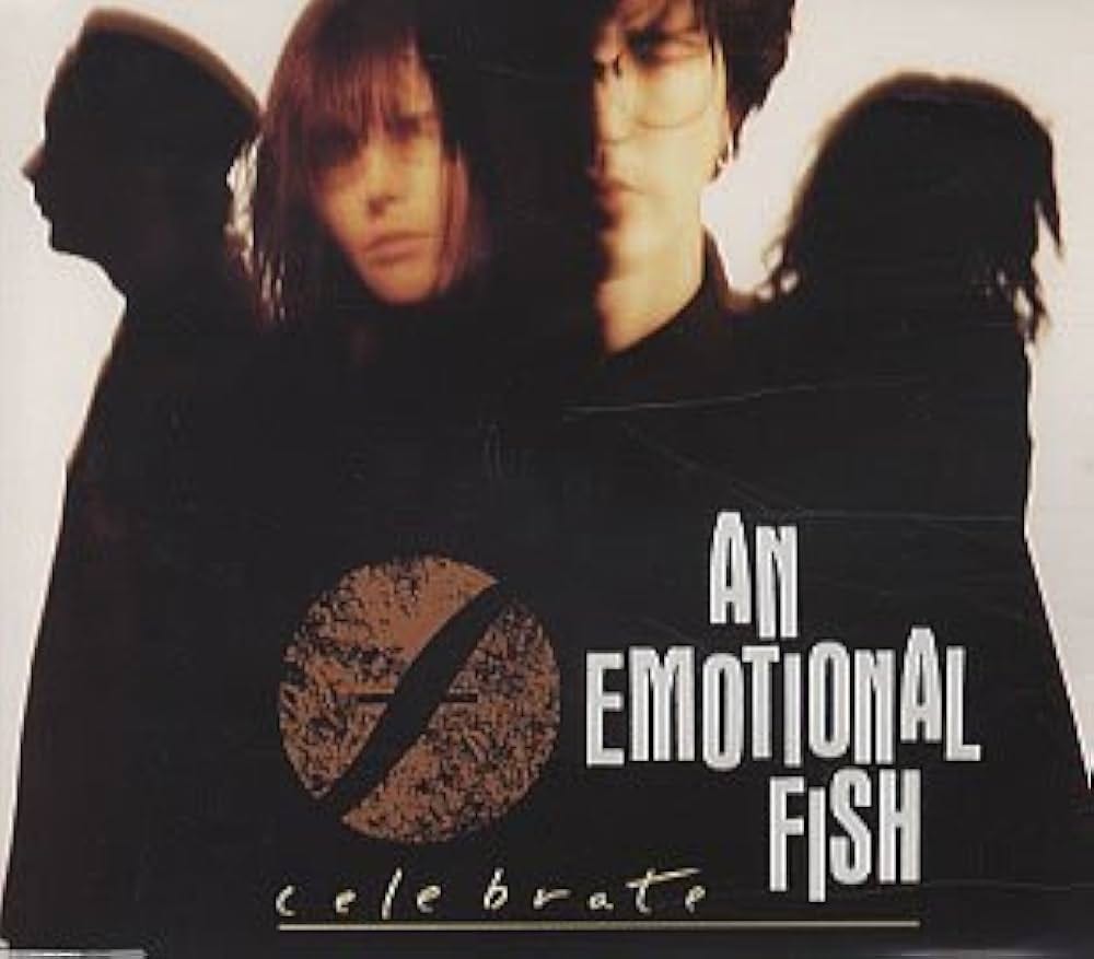 The cover of the Celebrate single. A moody photo of the band.