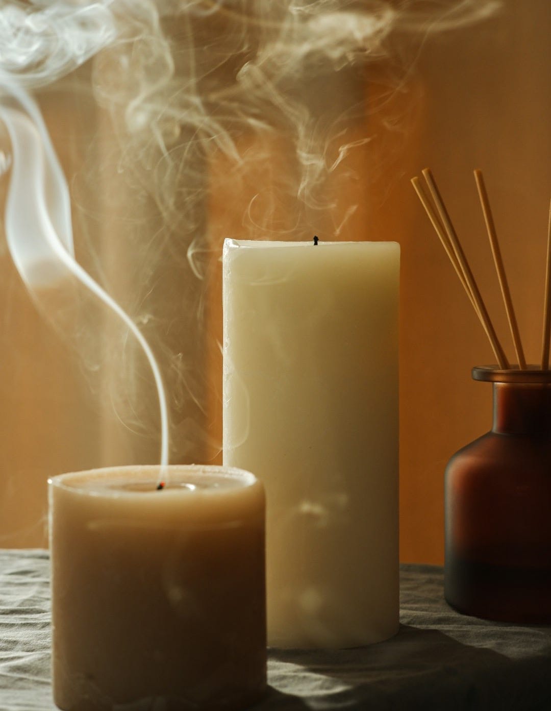 a couple of candles sitting on top of a table a couple of candles sitting on top of a table