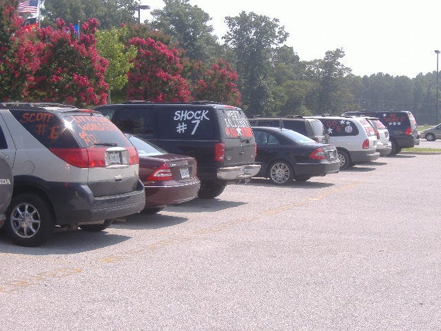 Another shot of some proud parents' cars and SUV's. Another shot of some proud parents' cars and SUV's.