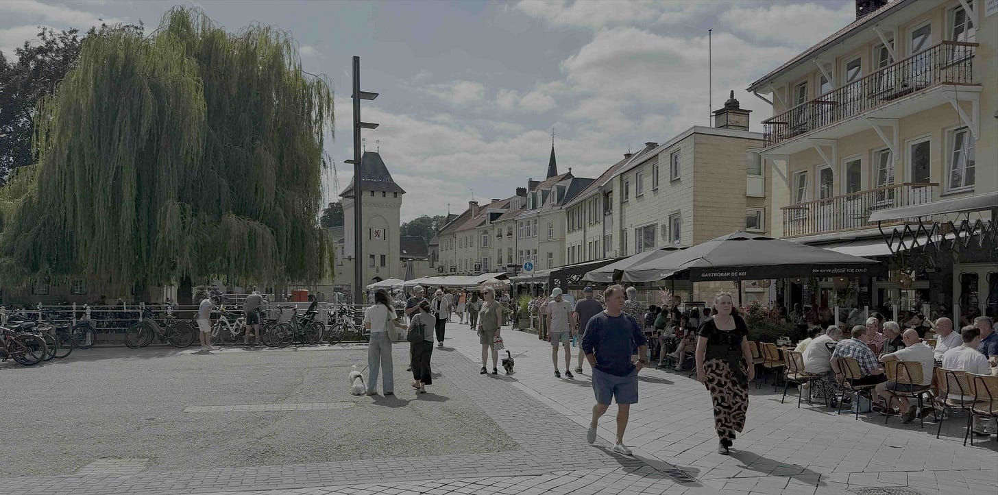 Sunlit town square in Valkenburg, Limburg, Netherlands. A large weeping willow and rows of parked bicycles line the left; on the right, a busy café terrace sits under dark umbrellas. People in summer clothes stroll across light-gray cobblestones toward an old stone gate tower with a red-and-white crest, while pastel-yellow buildings with balconies and a distant church spire frame the scene. Sunlit town square in Valkenburg, Limburg, Netherlands. A large weeping willow and rows of parked bicycles line the left; on the right, a busy café terrace sits under dark umbrellas. People in summer clothes stroll across light-gray cobblestones toward an old stone gate tower with a red-and-white crest, while pastel-yellow buildings with balconies and a distant church spire frame the scene.
