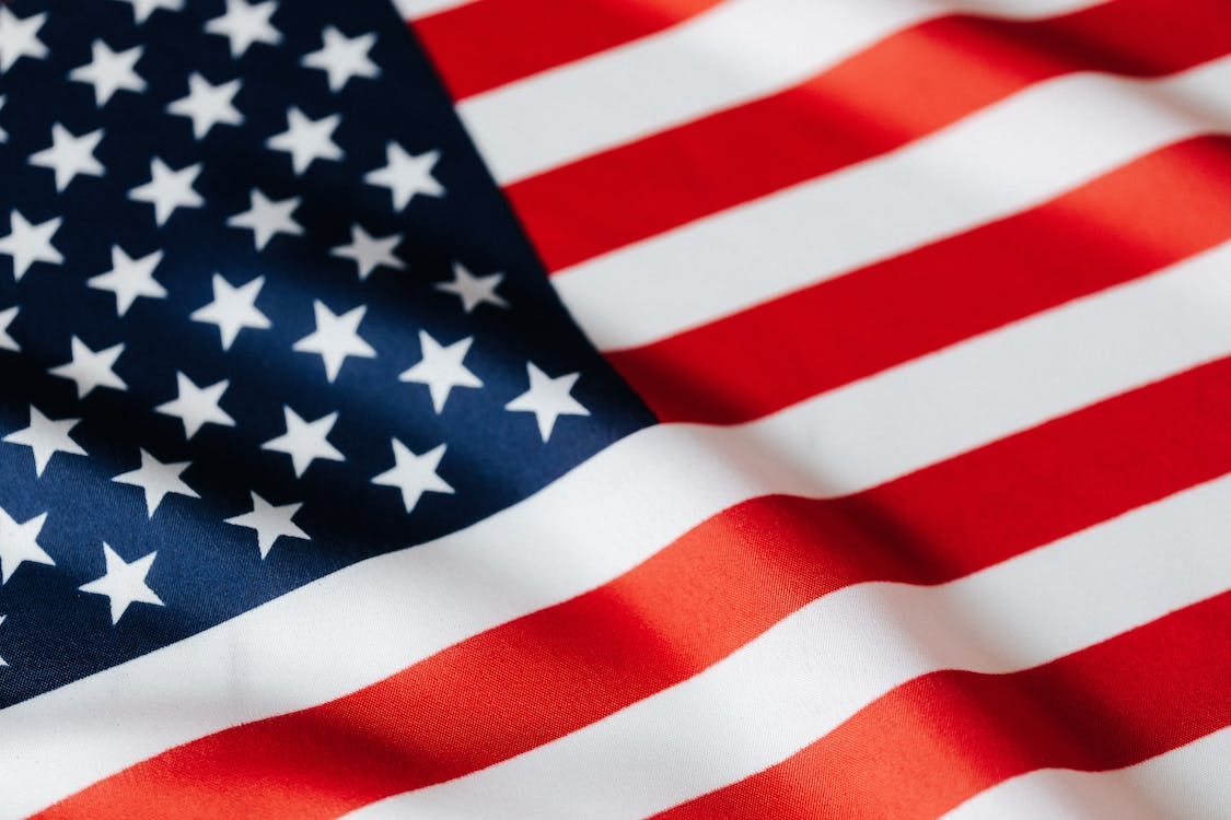 Free From above of closeup flattering national flag of USA with white and red stripes and stars on blue background Stock Photo Free From above of closeup flattering national flag of USA with white and red stripes and stars on blue background Stock Photo