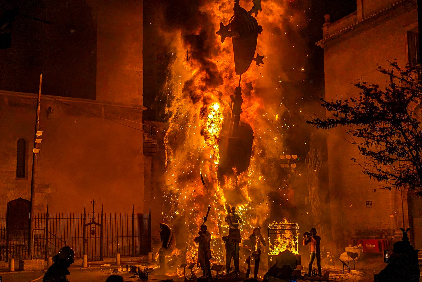 A falla engulfed in orange flames and black smoke. 