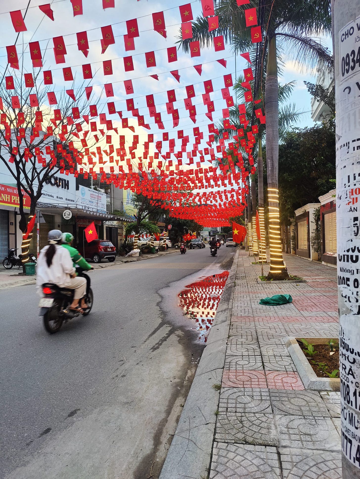 Tết flags up and a motorbike goes by