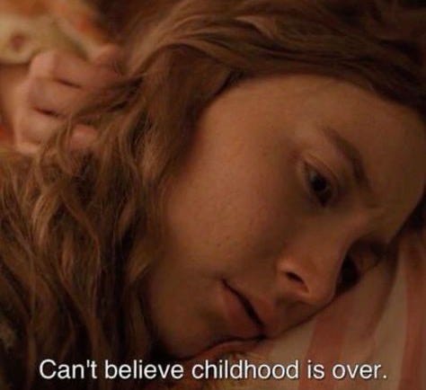 This may contain: a woman laying in bed with her head on the pillow and text that reads, can't believe childhood is over