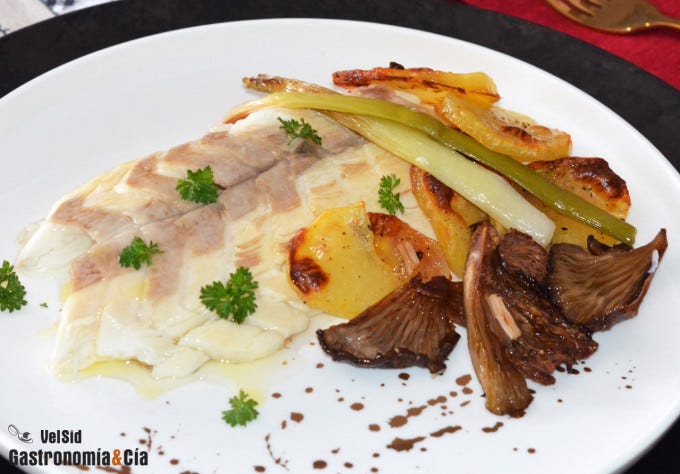 Lubina salvaje al horno con patatas y ajos tiernos