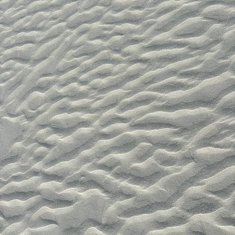 three views of beach sand with different textures and patterns made by water and wind