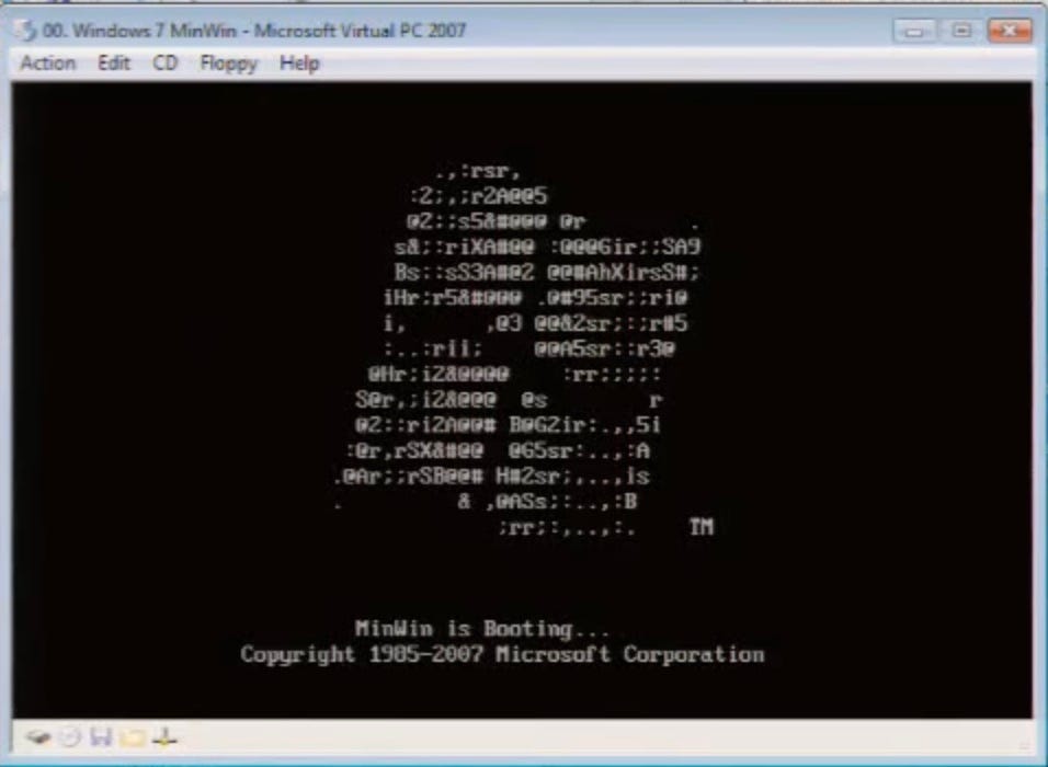 A command window showing MinWin booting. The boot screen is all characters with a Windows flag made out of ASCII art. The text is "MinWin is Booting, copyright Microsoft 1985-2007 A command window showing MinWin booting. The boot screen is all characters with a Windows flag made out of ASCII art. The text is "MinWin is Booting, copyright Microsoft 1985-2007