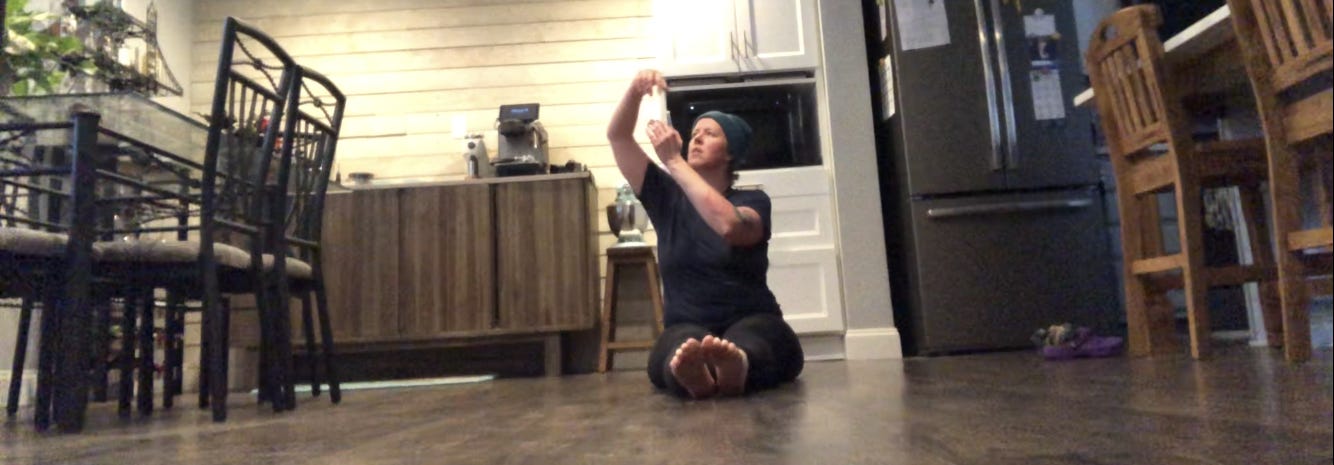 A person dances in a kitchen.
