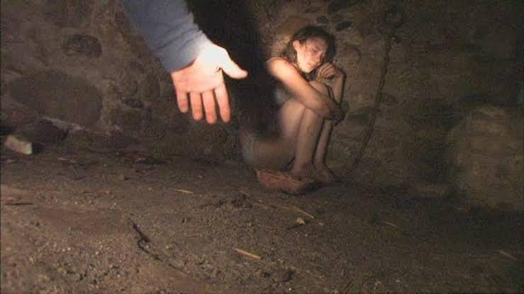 Close-up of Amy chained and terrified in a dark room, highlighting the film’s descent into graphic trauma exploitation masked as a PSA.