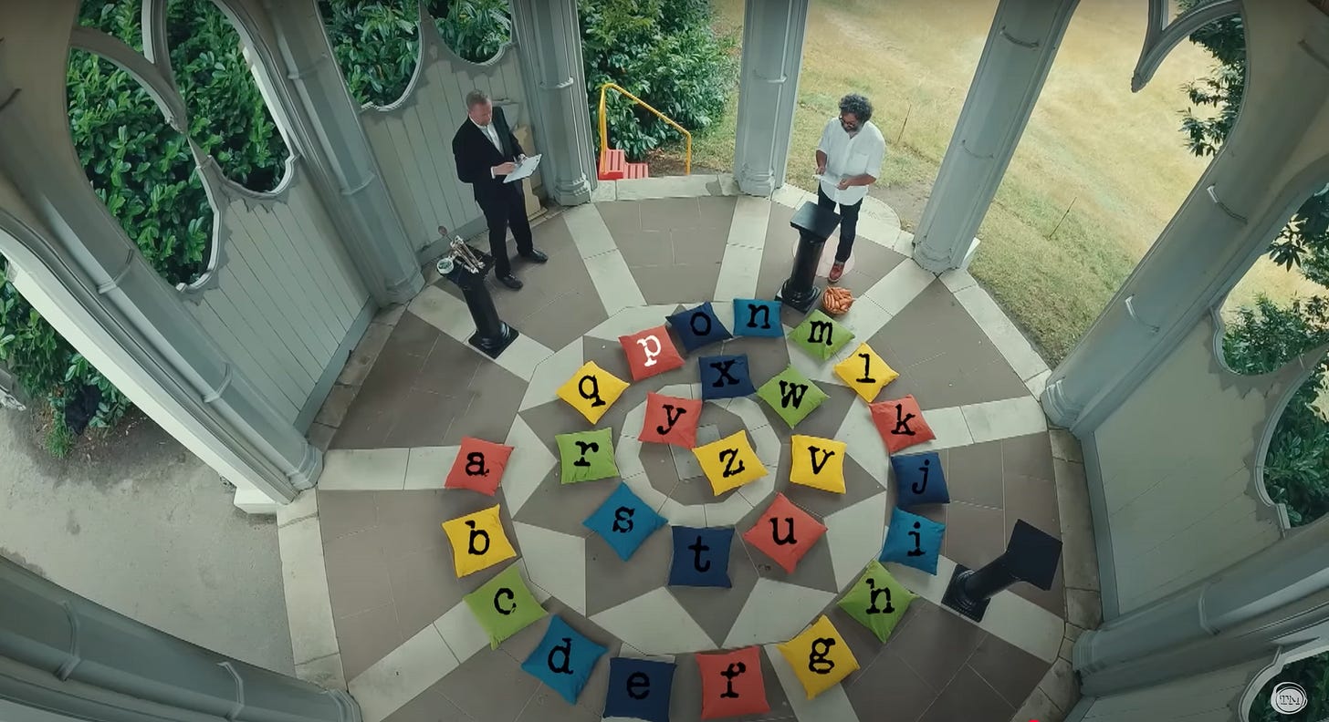 A spiral of 26 colored pillows, each labeled with a letter of the alphabet. A spiral of 26 colored pillows, each labeled with a letter of the alphabet.