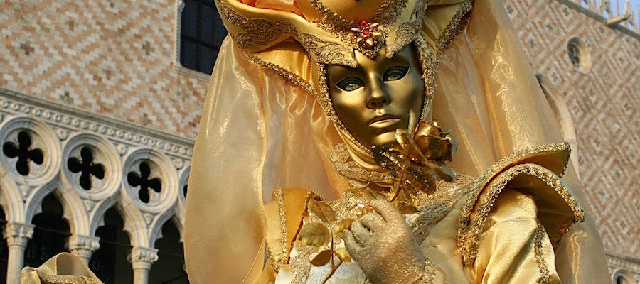 Person wearing golden mask Person wearing golden mask
