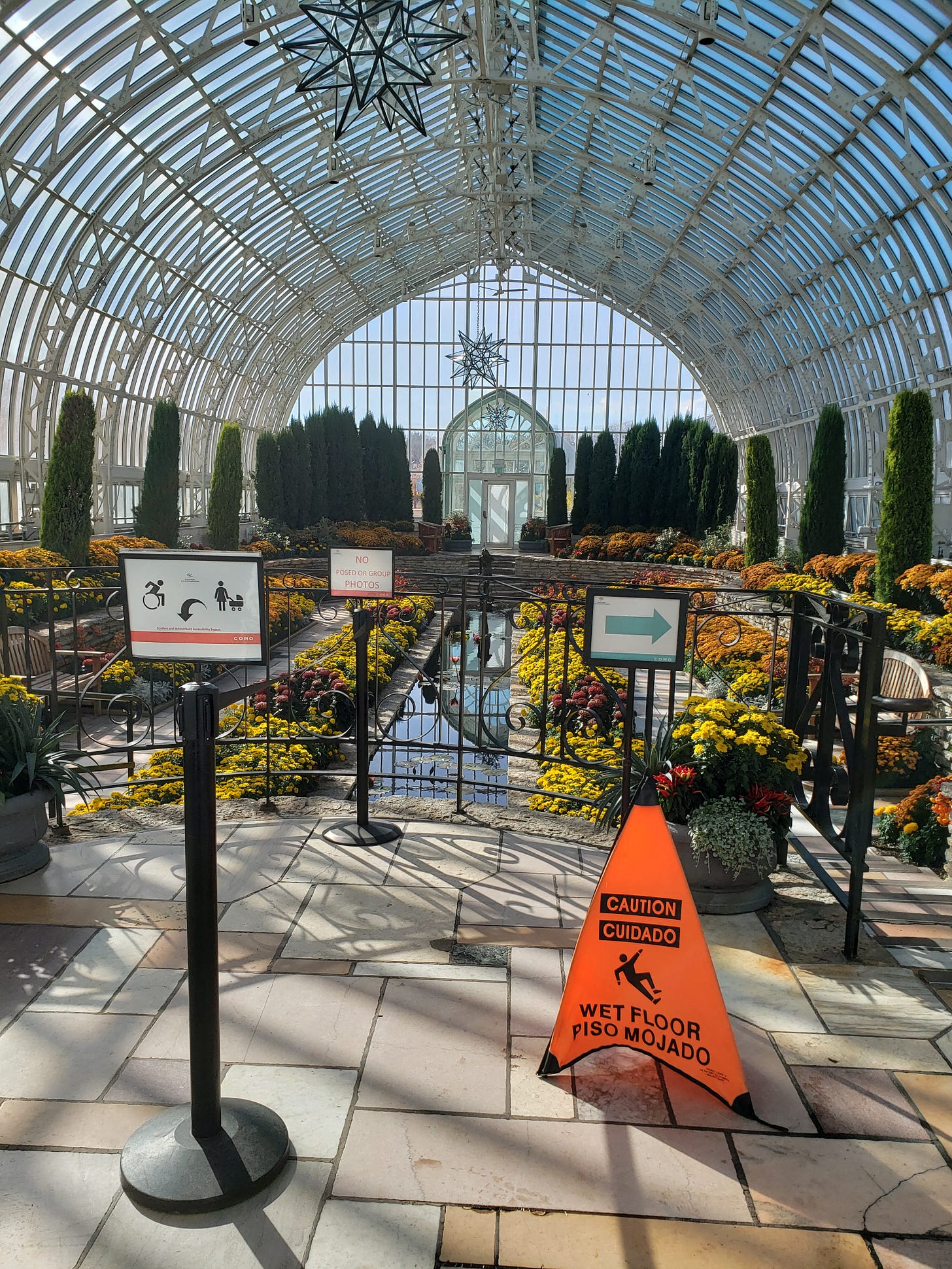 The entrance to the Sunken Gardens with multiple signs communicating various expectations and accessibility options.