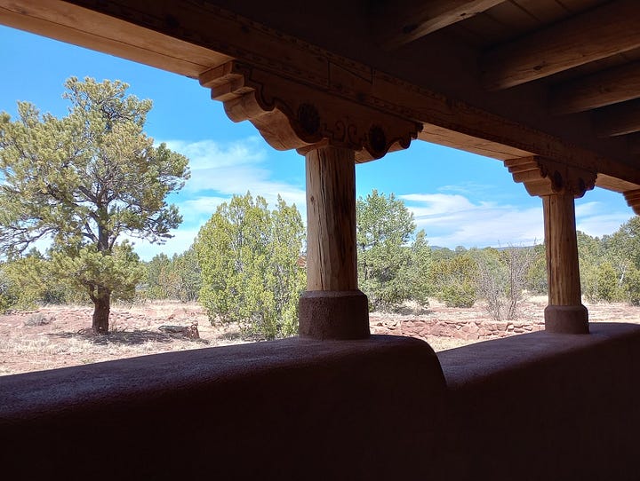 Gift shop with books and souvenirs, museum displays including basketry and diorama of the Pecos Pueblo, view from cloister of semi-desert with trees