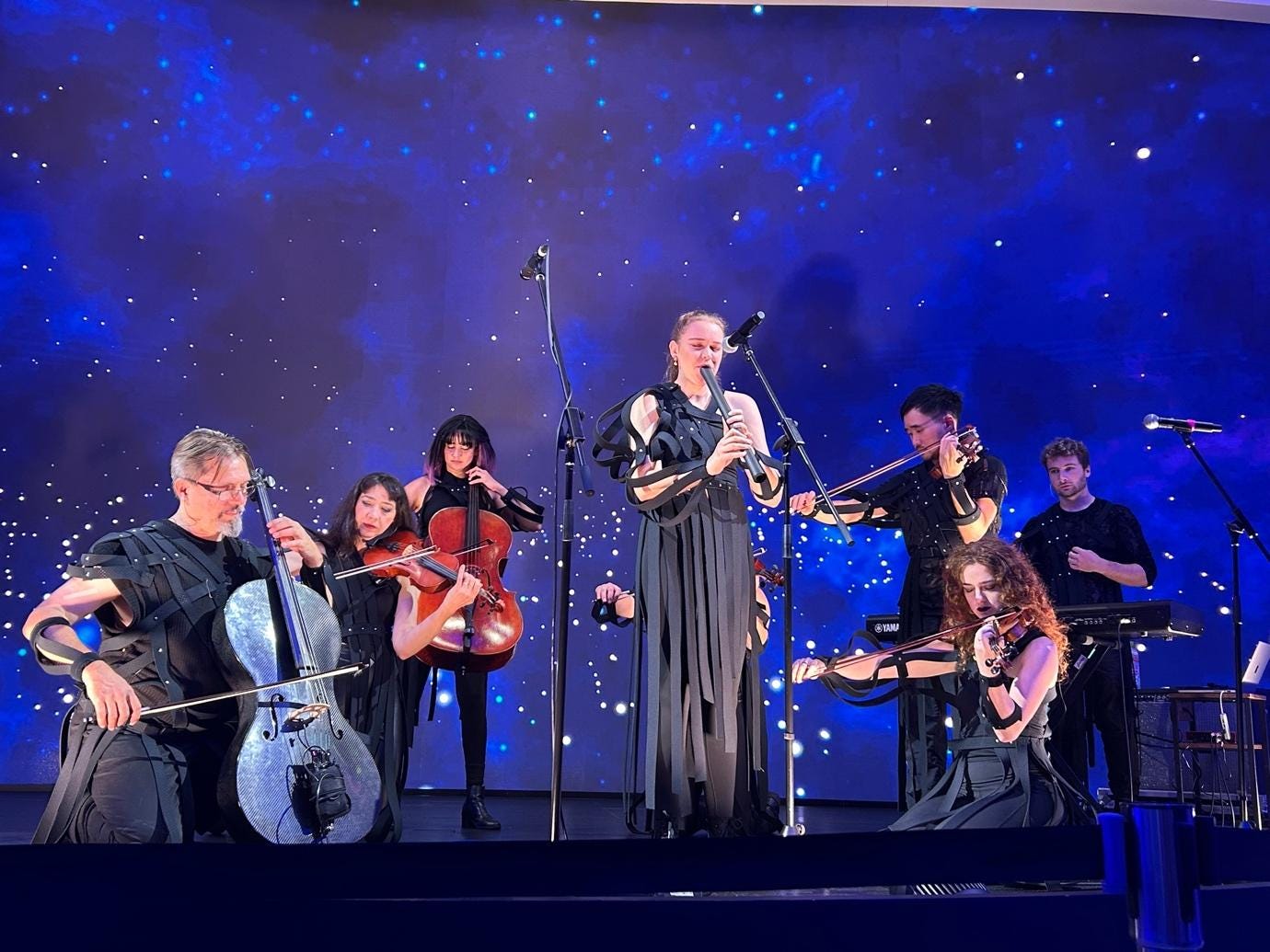 A group of people playing instruments

AI-generated content may be incorrect.
