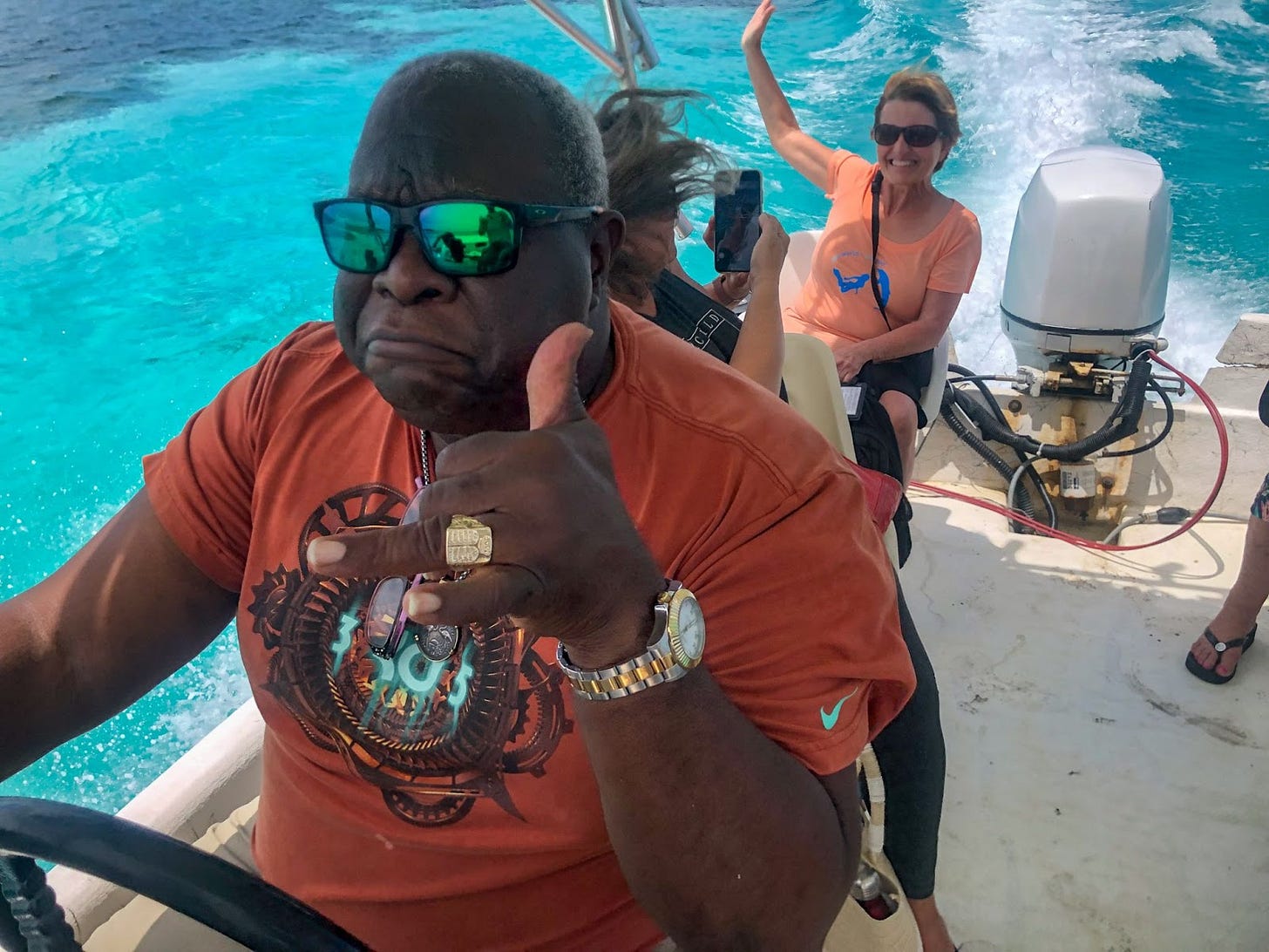 Bahamian boat captain with 2 passengers visible