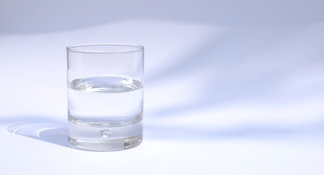 clear drinking glass filled with water