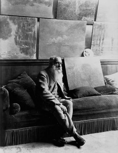 Claude Monet sitting in his studio at Giverny surrounded by paintings, photographed by Henri Manuel, 1920. The Paragone