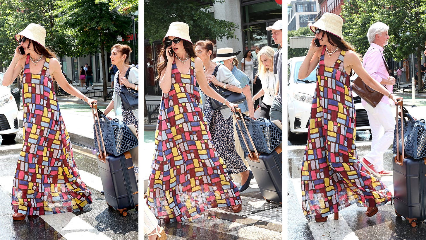 Anne Hathaway on set in NYC for The Devil Wears Prada 2 wearing a colourful dress and straw hat