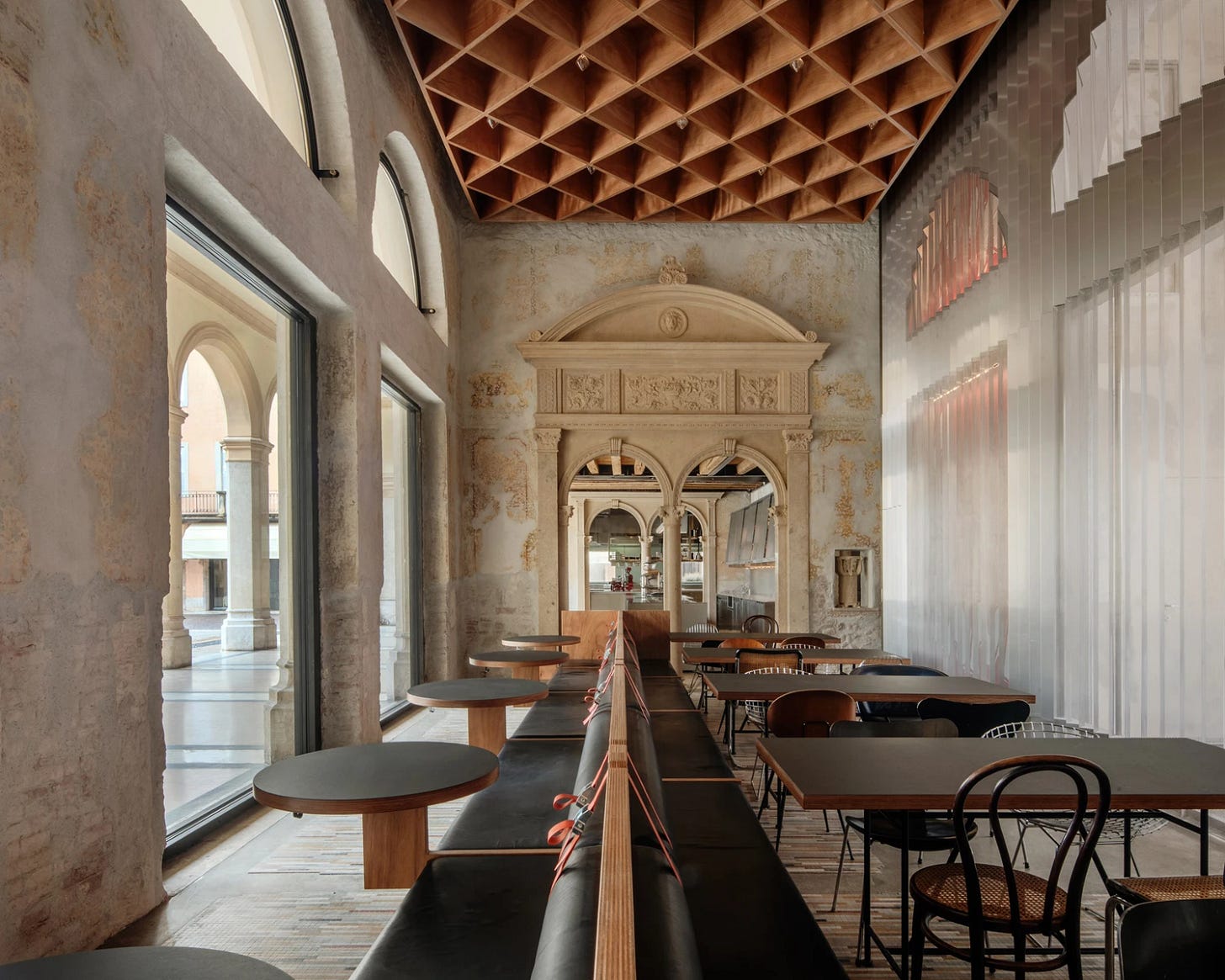 Caffè Nazionale by AMAA in Arzignano Italy, adaptive reuse of 19th-century palazzo with pleated stainless steel walls, okumè plywood ceiling and preserved historical patinas Caffè Nazionale by AMAA in Arzignano Italy, adaptive reuse of 19th-century palazzo with pleated stainless steel walls, okumè plywood ceiling and preserved historical patinas