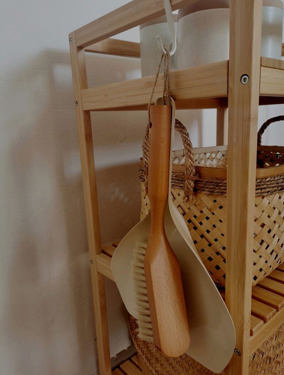 Wooden broom hanging of wooden kitchen table
