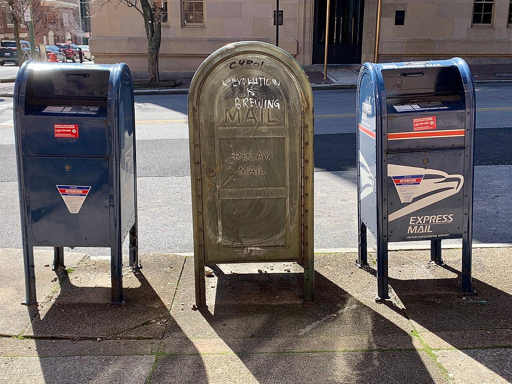 Picture with three USPS mailboxes, described as follows: A regular US Postal Service mailbox, a letter carrier box, and an express only box