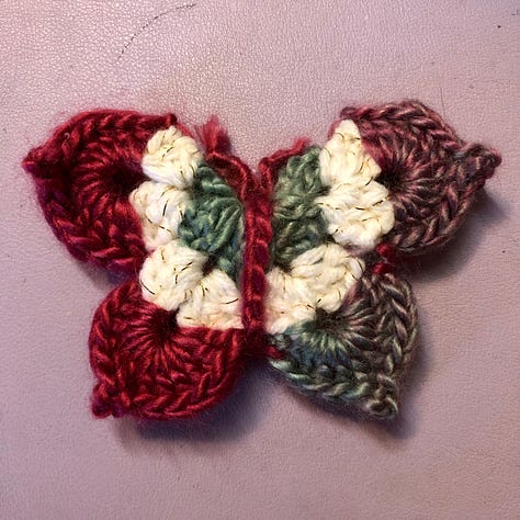 Nine multi-coloured crocheted butterflies