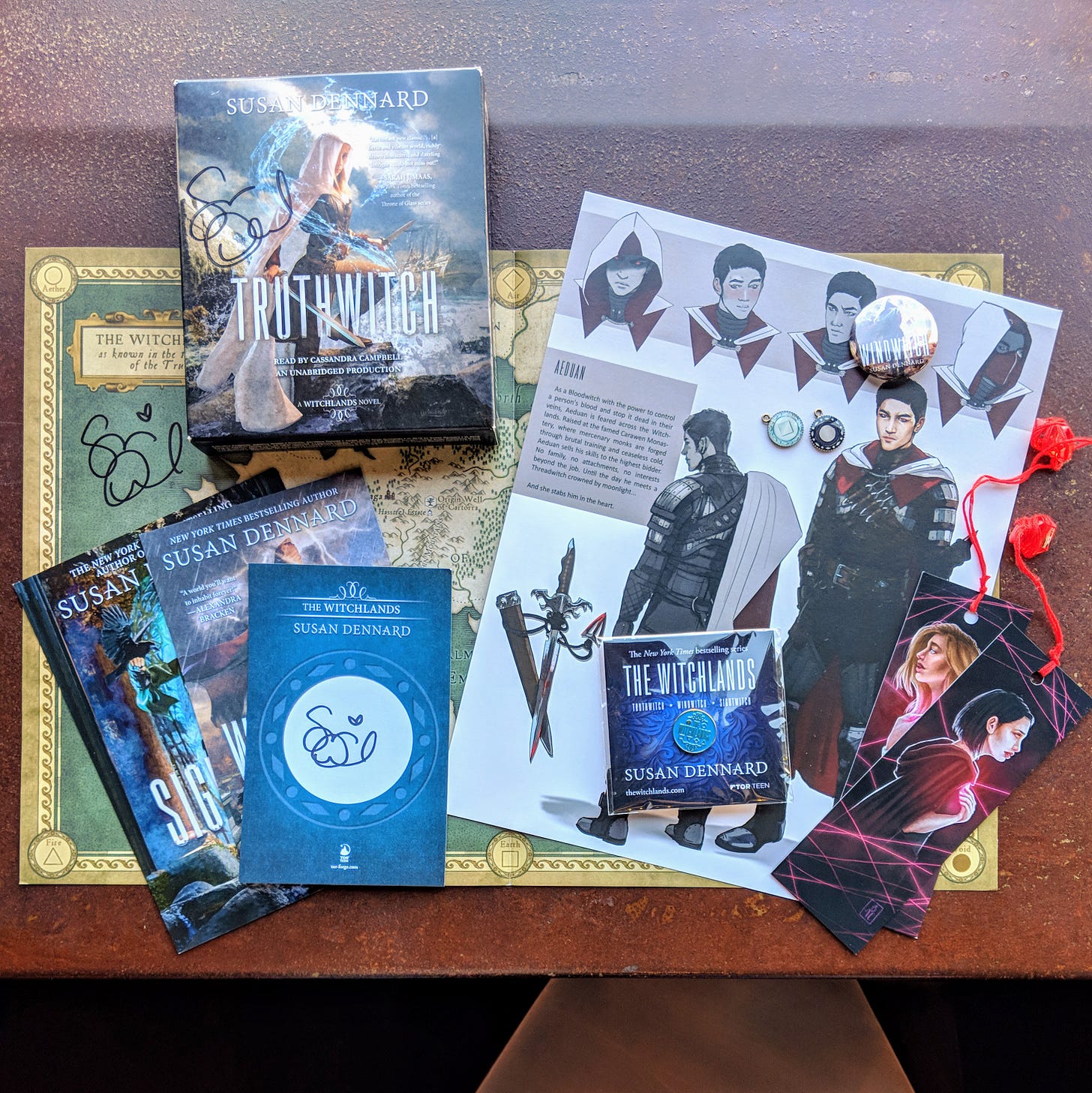 Examples of Witchlands swag including bookmarks, post cards, book plates, buttons, pins, charms, posters, and maps Examples of Witchlands swag including bookmarks, post cards, book plates, buttons, pins, charms, posters, and maps