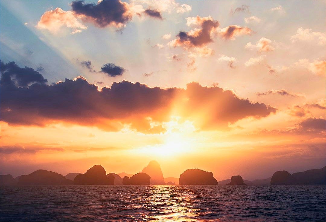 body of water under cloudy sky during sunset body of water under cloudy sky during sunset