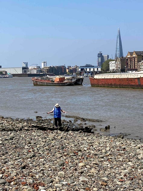 Women on the banks of the River Thames. She is mudlarking. The Shard buidling is in the background. The second image is of colourful piece of glass found in the mud. The third image shows pebbles with many rusty nails and pieces of metal from scrapped sailing vessels.