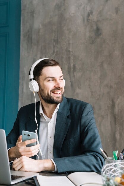 Free photo businessman listening to music and looking away
