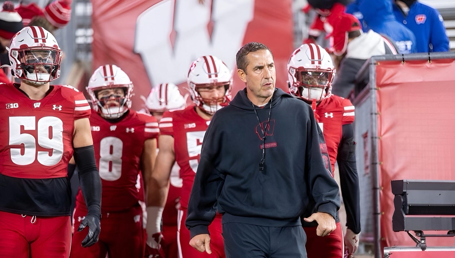 Luke Fickell walks ahead of the Wisconsin Badgers as they take the field at Camp Randall Stadium before facing Illinois.