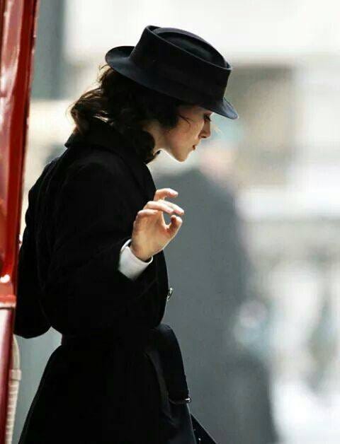 May be an image of overcoat and hat