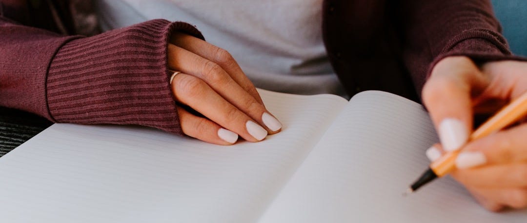 person writing on white paper
