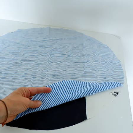 two circular pieces of fabric right sides facing, ready to be sewn together two circular pieces of fabric right sides facing, ready to be sewn together