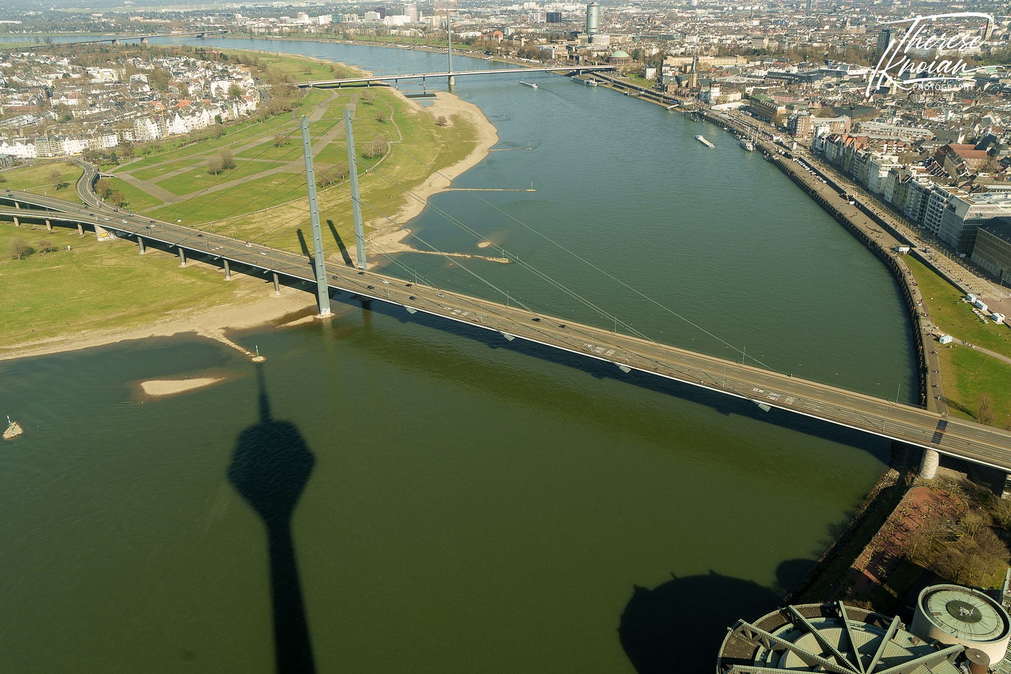 Rhine tower shadow on the Rhine River and the Düsseldorf waterfront. 
