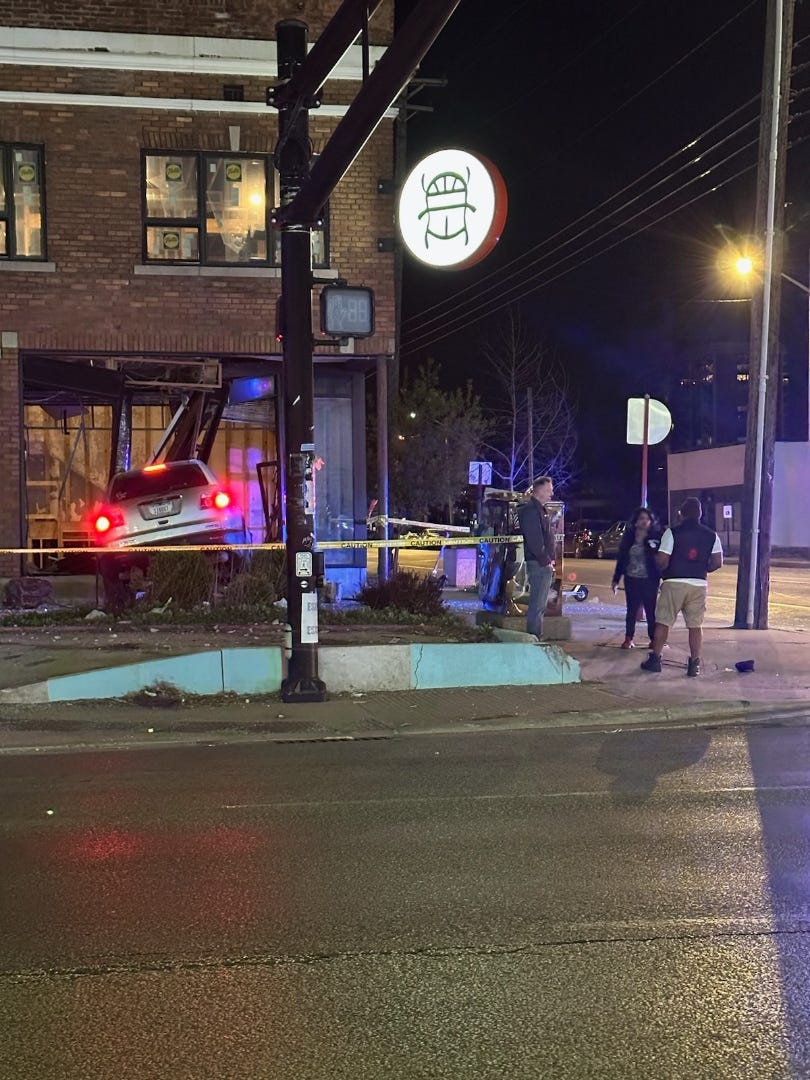 Picture of a car crashed through the window and wall of a building