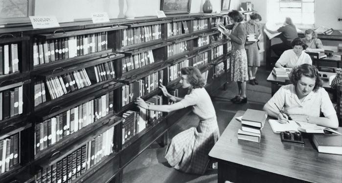 A historical photo of women reading in a library.