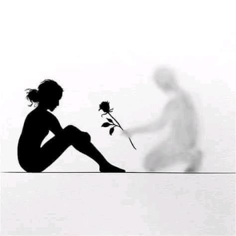 This may contain: a person sitting on the ground with a flower in front of them and a shadow behind it